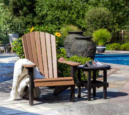 Adirondack chair with side table by the pool.